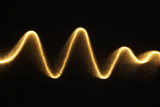 A gold sine-wave of light on black — focus without burnout