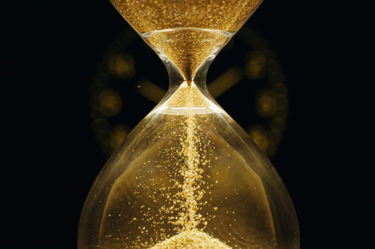 A golden hourglass on black — understanding time blindness