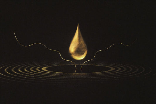 Gold droplet and ripples on black — how often to wash your hair