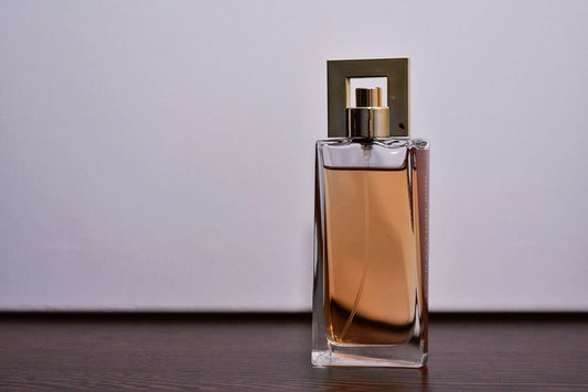 Transparent glass perfume bottle on a wooden surface