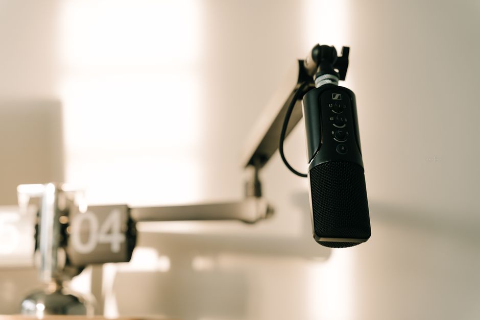 Professional microphone on a boom arm in a studio