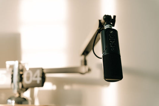 Professional microphone on a boom arm in a studio