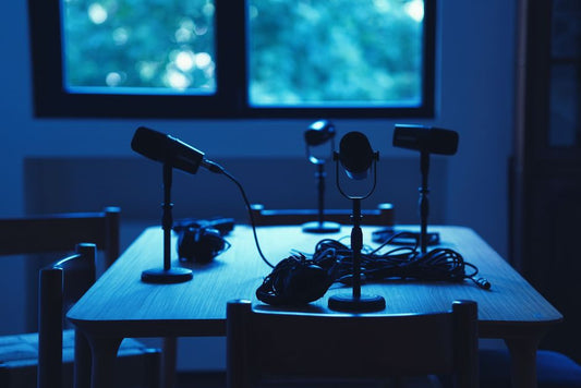 Podcast studio with microphones and headphones on a table
