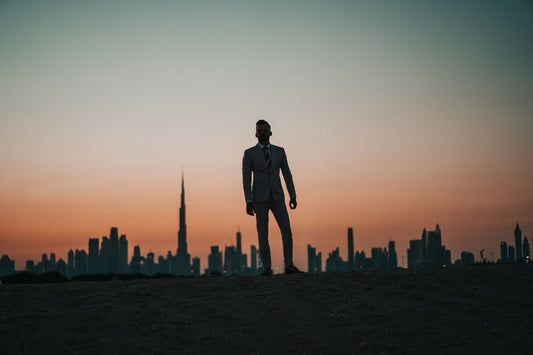 Entrepreneur silhouetted against a city skyline at twilight — facing the next decade of business