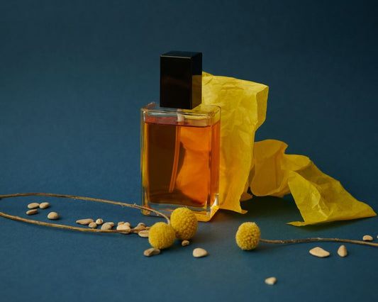 Glass perfume bottle still life with floral accents